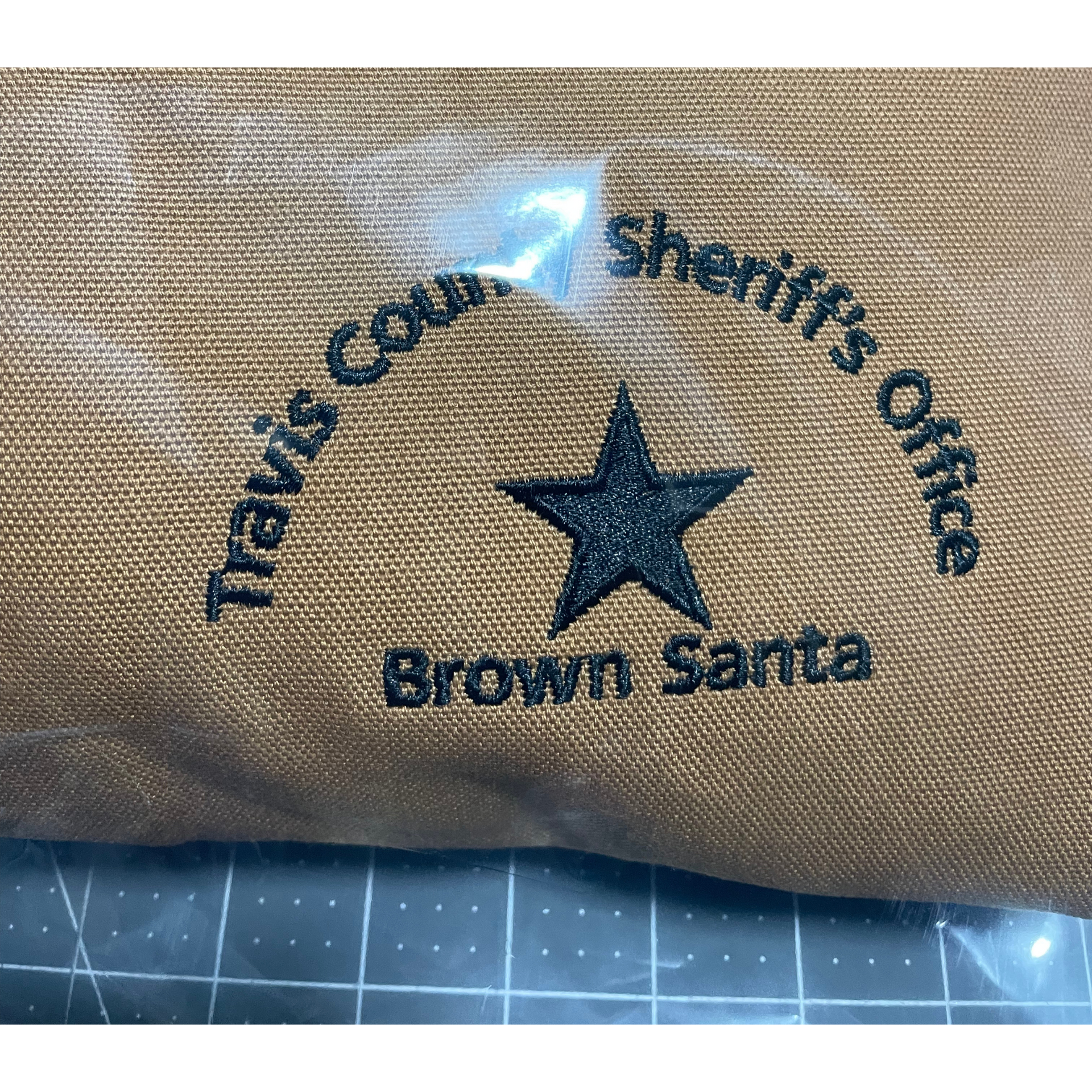 Brown Santa tote with Travis County Sheriff’s Office logo and star on tan fabric
