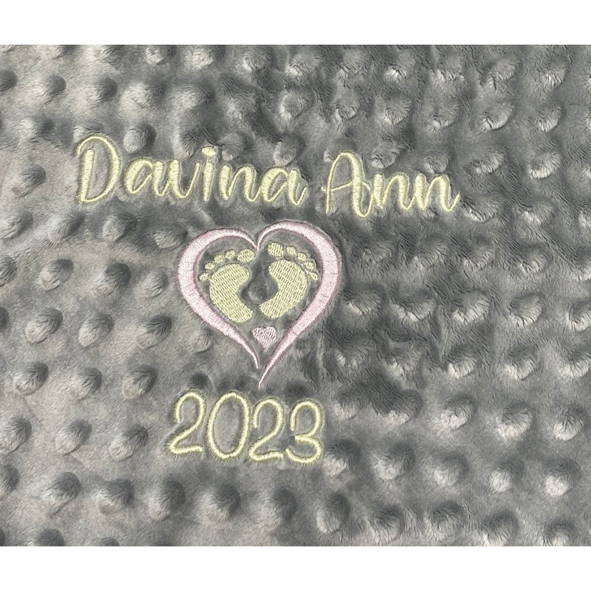 “Davina Ann” and “2023” in gold on a gray textured background, with a pink heart and silhouette design.