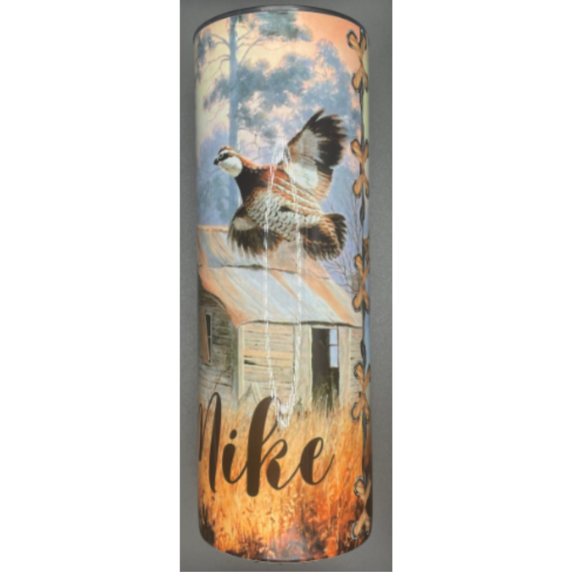 Cylindrical tumbler with a flying duck, barn, and “like” text over a sunset grass scene.