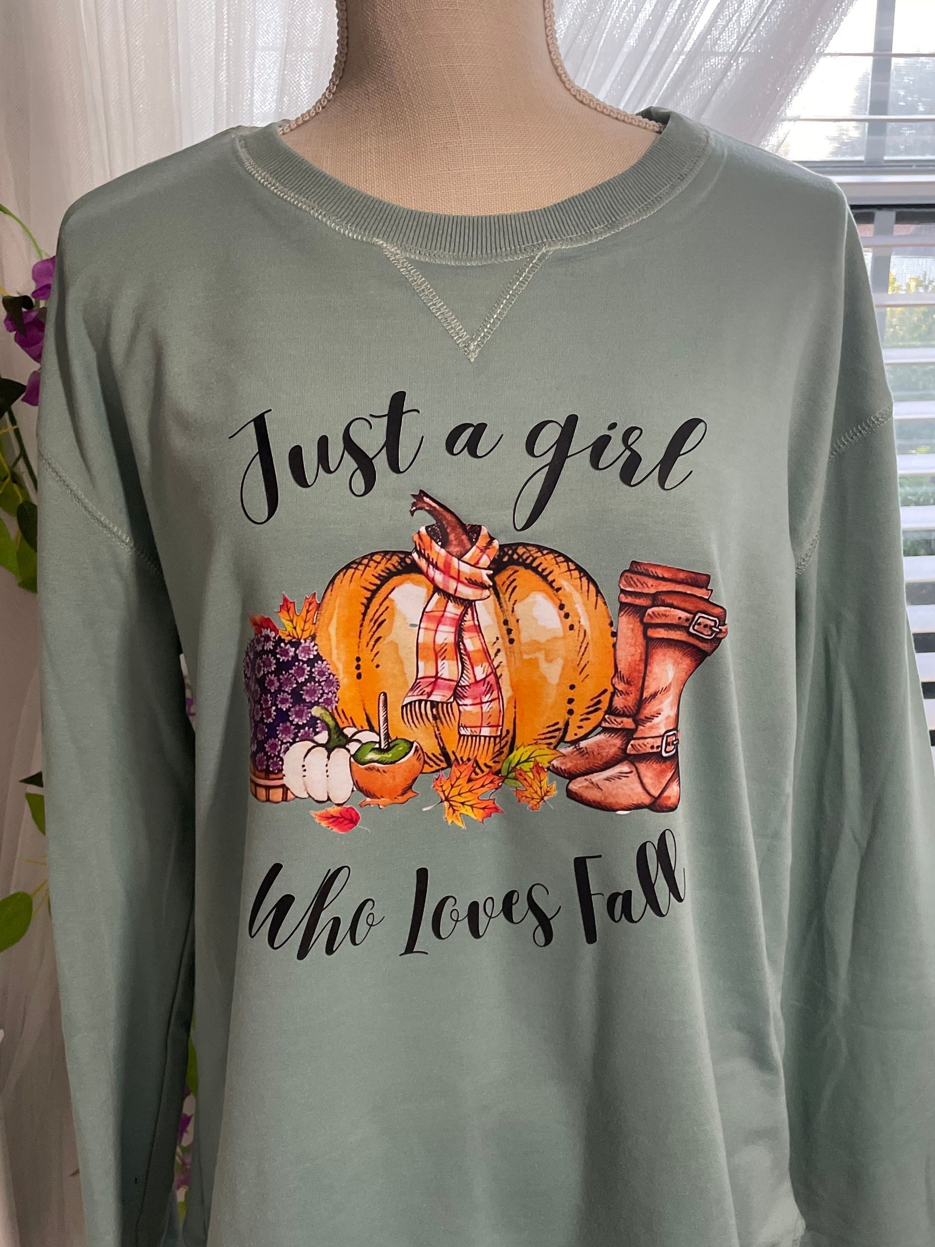 Gray sweatshirt with “Just a girl that loves fall” and autumn pumpkins graphic