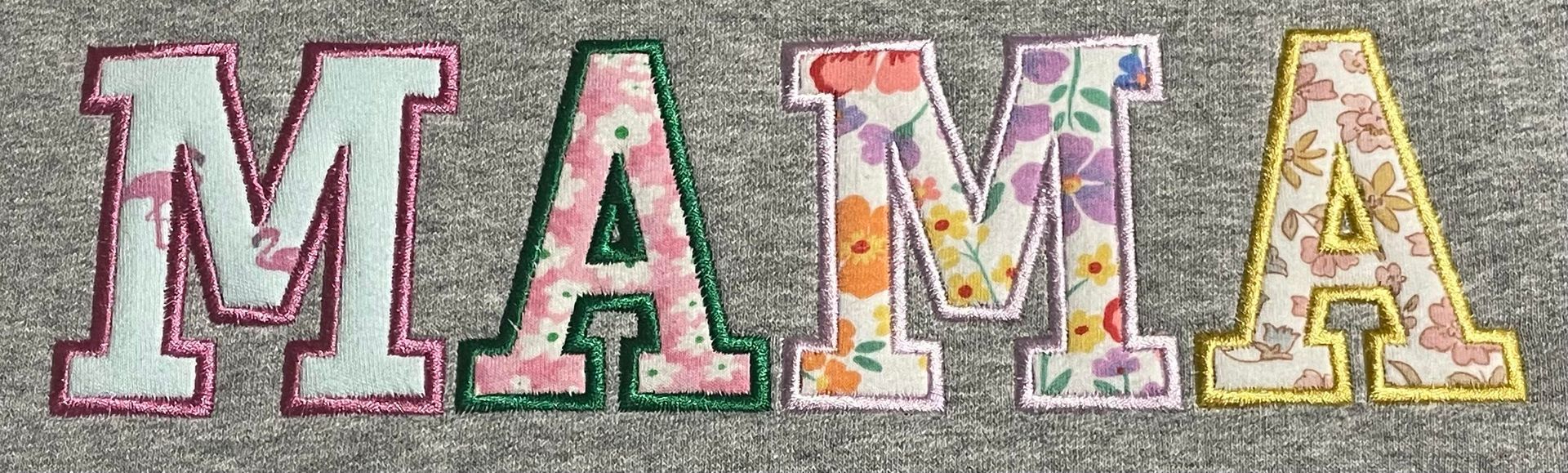 Colorful floral “MAMA” letters on a light background