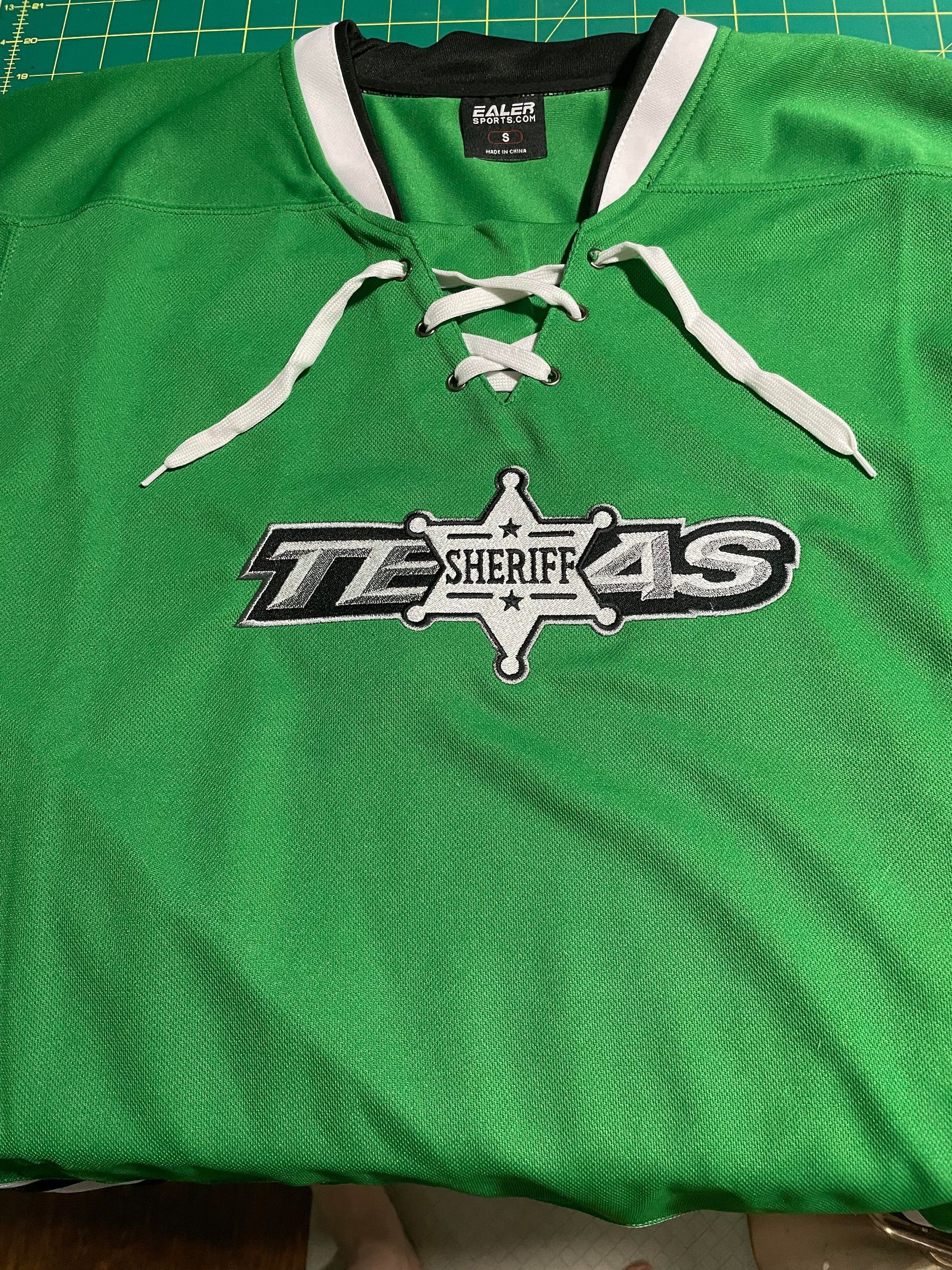 Green Texas Sheriffs jersey with white laces and a star logo on the chest.