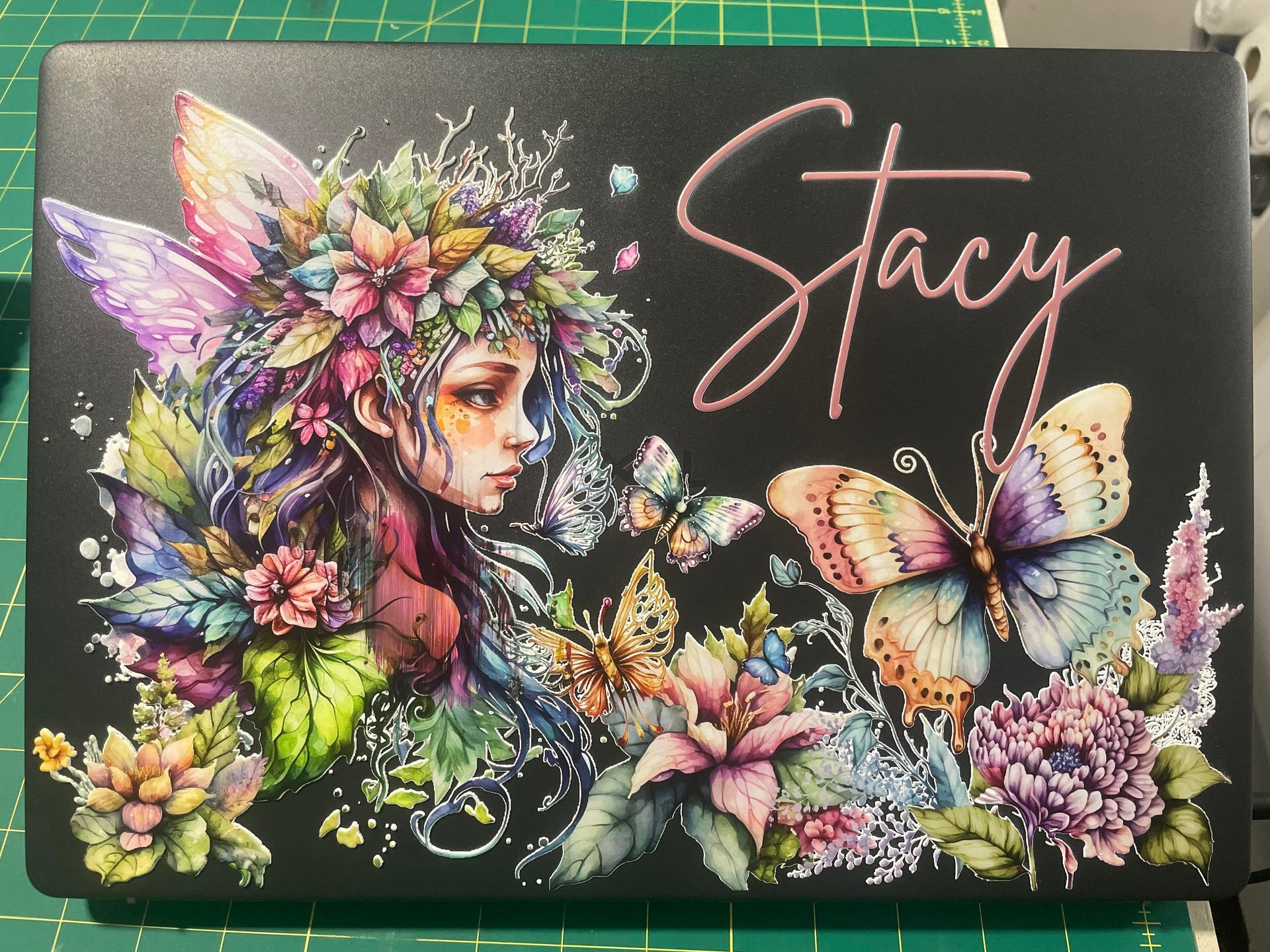 Colorful fairy portrait with butterflies and flowers, named “Stacy” in pink script on a dark background