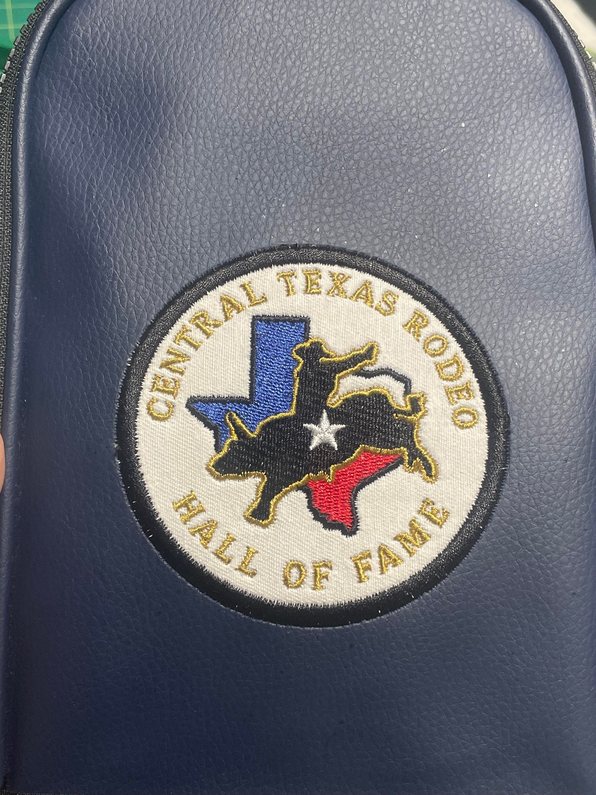 Circular Central Texas Rodeo Hall of Fame patch on blue fabric, with black, red, and blue Texas outline.