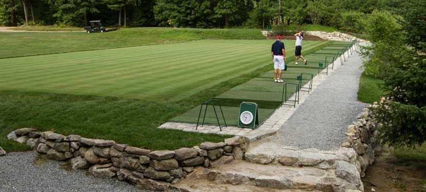 A group of people are playing golf on a golf course.