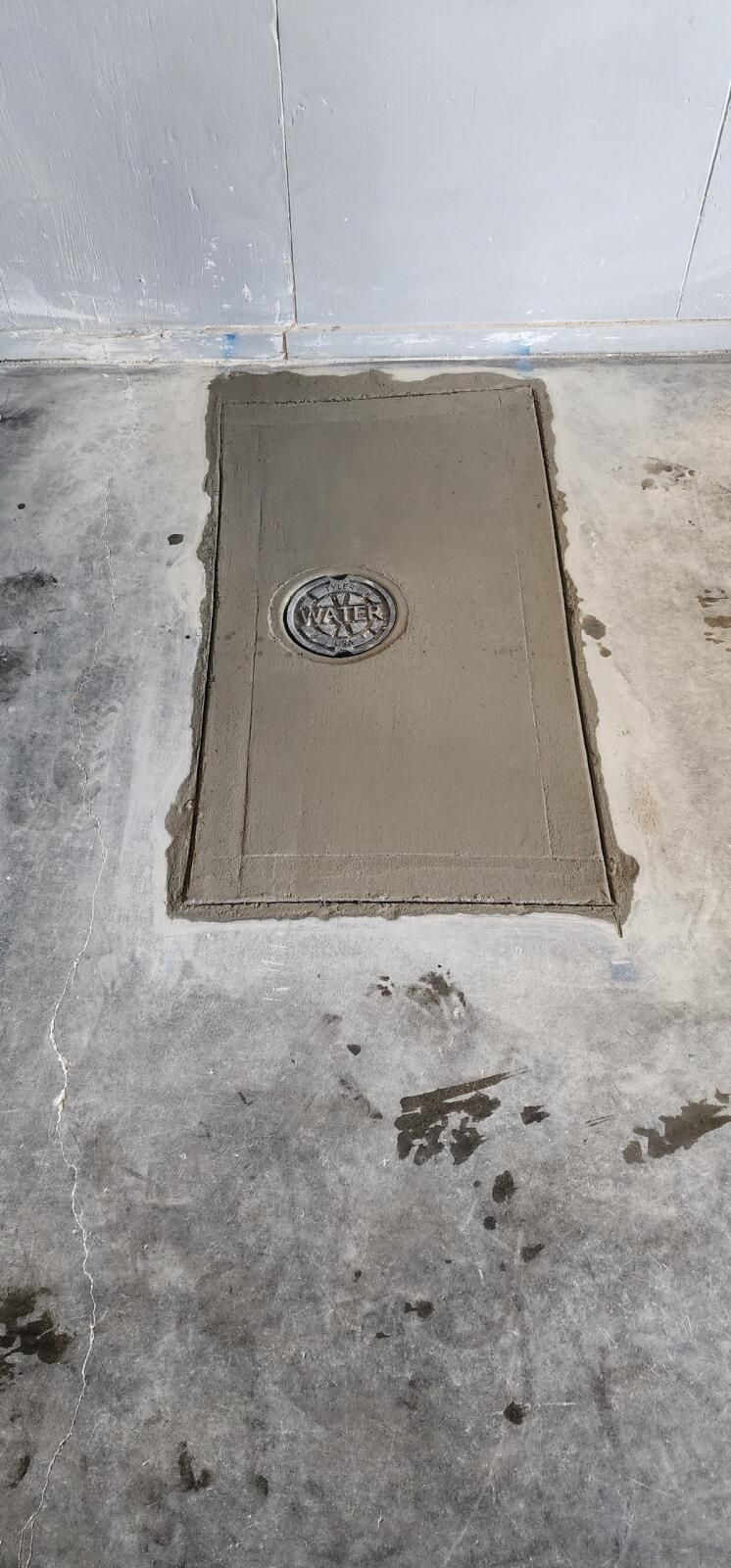 A Manhole Cover is Sitting on Top of a Concrete Floor