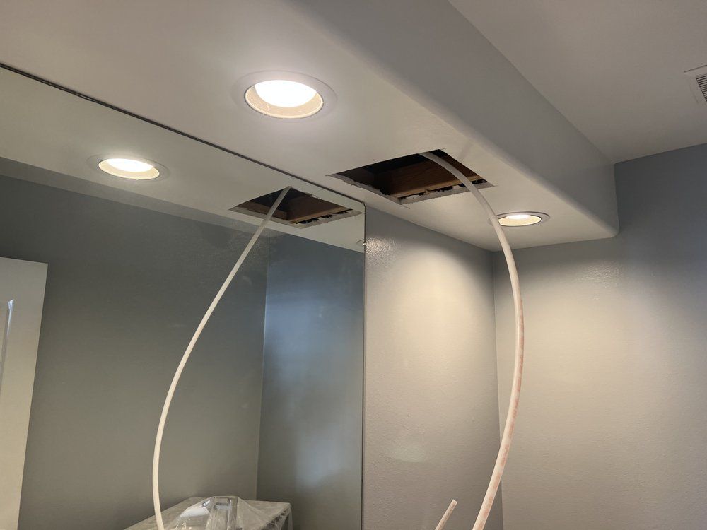 A Bathroom With a Mirror and Lights on the Ceiling