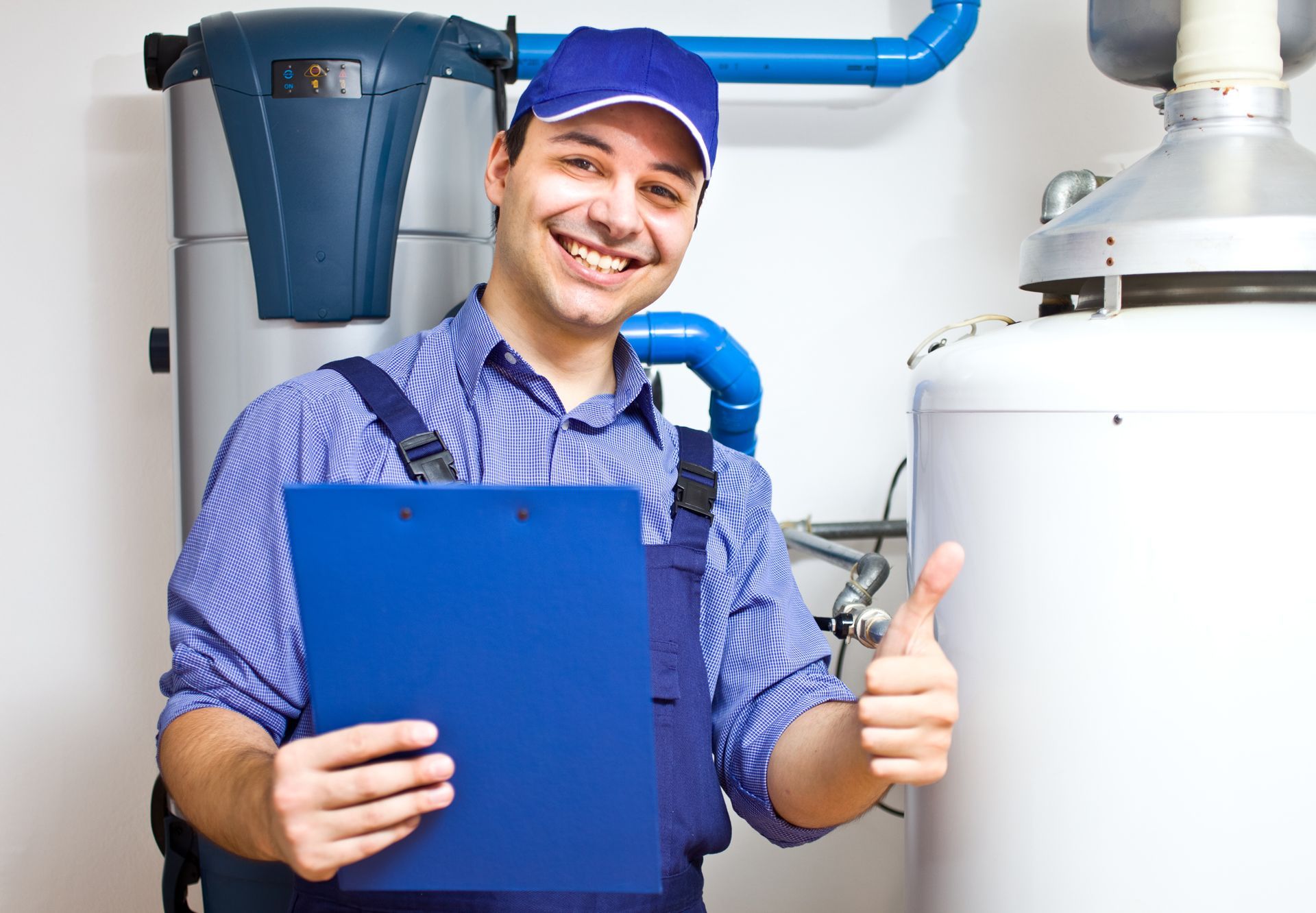 Smiling plumber giving a thumbs-up, holding a clipboard