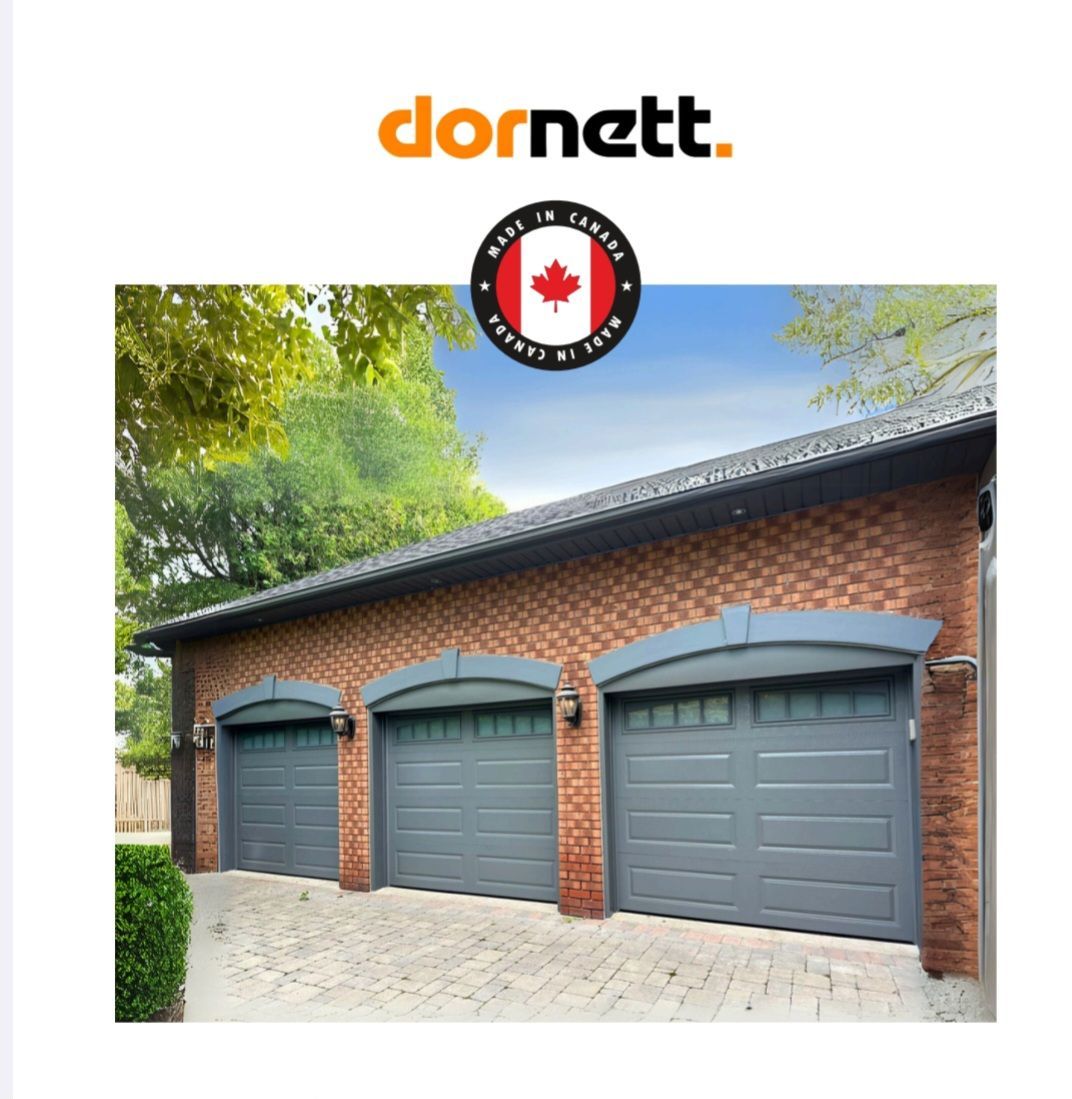 A garage with three gray doors, red brick, and a