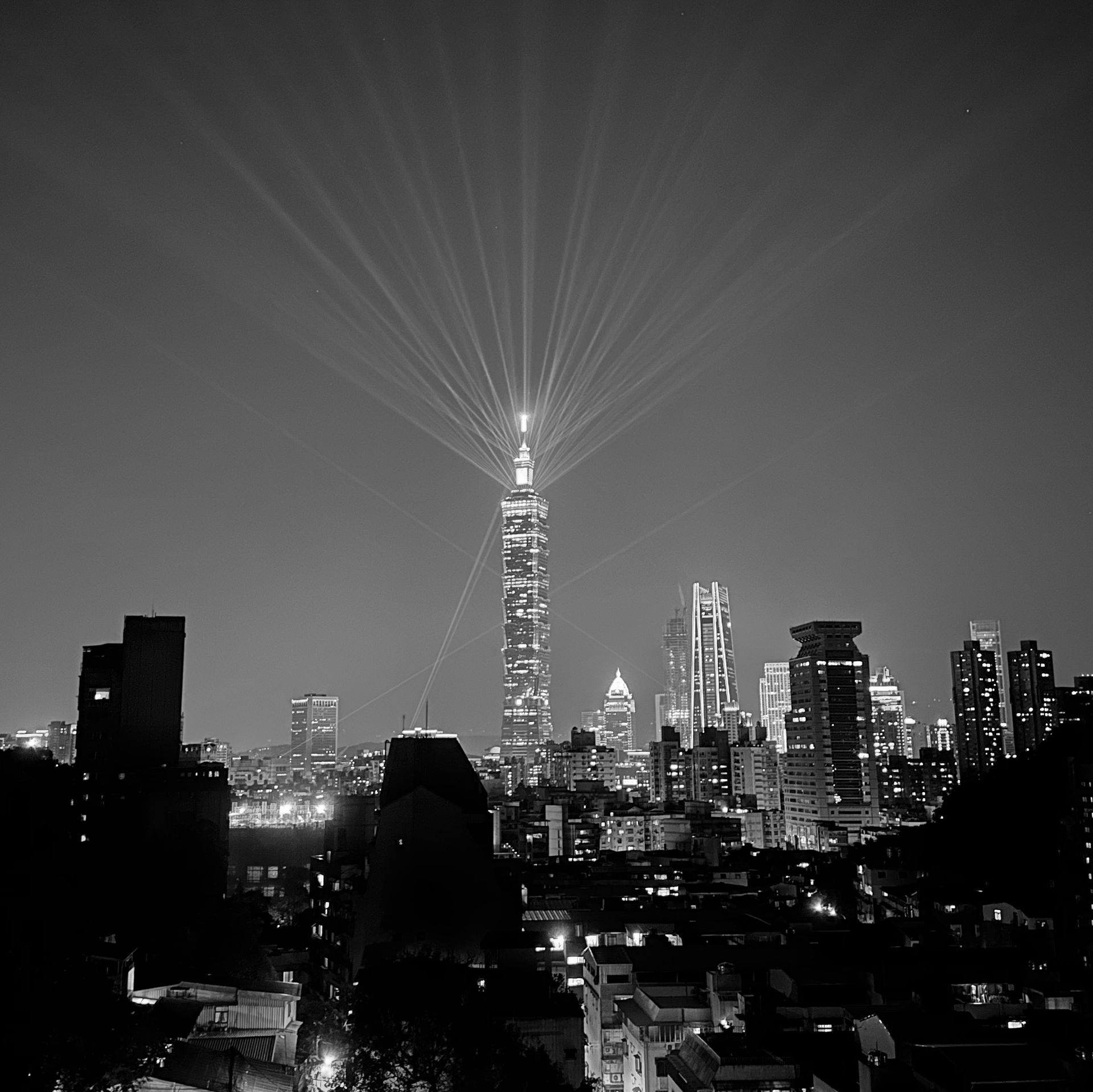 A black and white photo of a city skyline at night