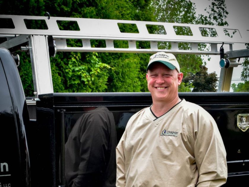 Gary Chagnon, President of Chagnon Building & Remodeling, standing near a CBR truck