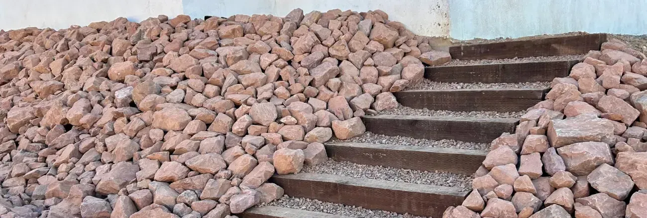 Landscape rock and gravel installation creating a low-maintenance outdoor area