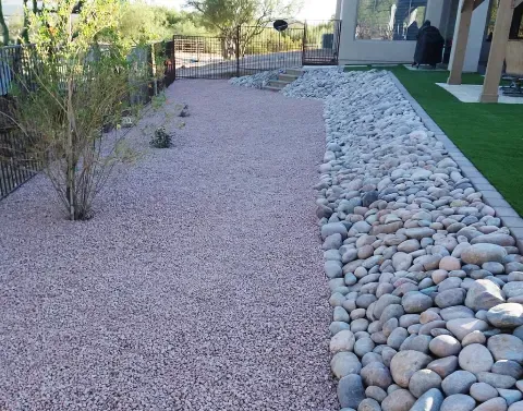 Desert rock landscaping using gravel and natural stone around outdoor areas
