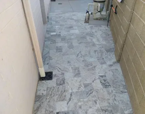Yard water drainage system directing runoff away from landscaped areas