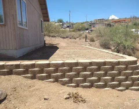 Garden retaining wall creating defined planting areas within a landscaped yard