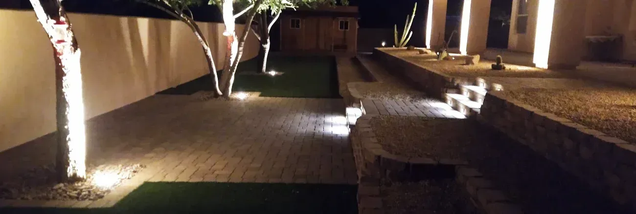 Landscape lighting illuminating a residential outdoor space at night