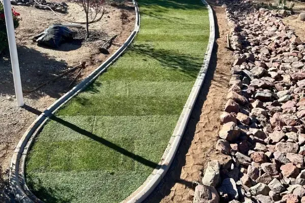 New lawn sod installation covering a prepared residential yard