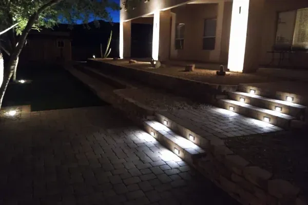 Outdoor landscape lighting highlighting features around a residential property
