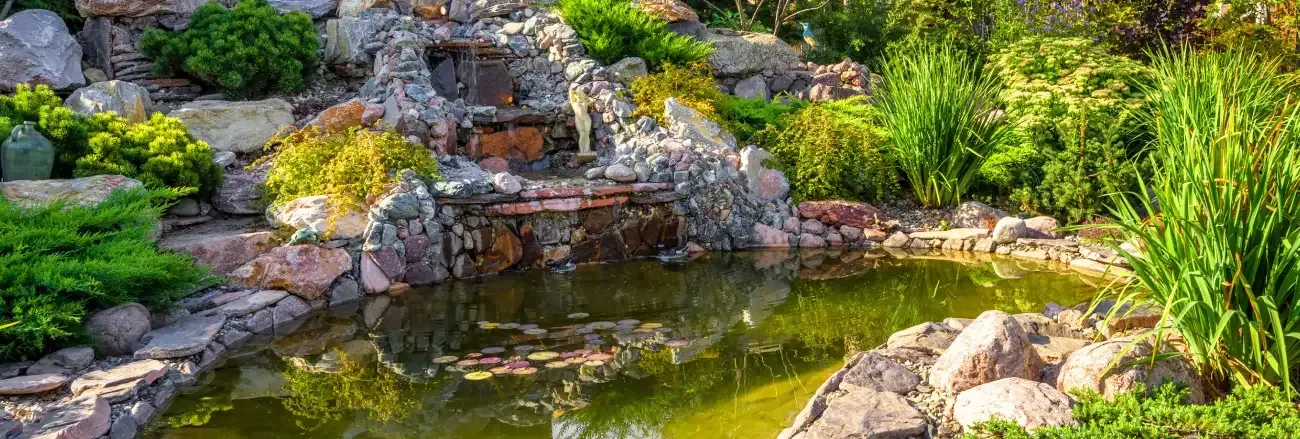 Pond and water feature creating a relaxing focal point in a landscaped yard