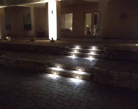 Residential landscape lighting enhancing an outdoor living area after dark
