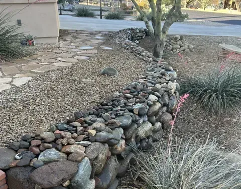 Residential retaining wall helping stabilize a sloped outdoor area