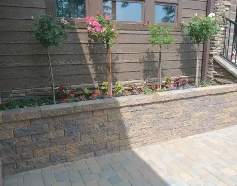 Retaining wall construction creating a stable boundary within a landscaped property