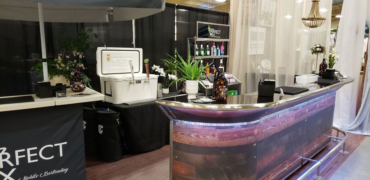 A bar with a cooler on top of it in a room.