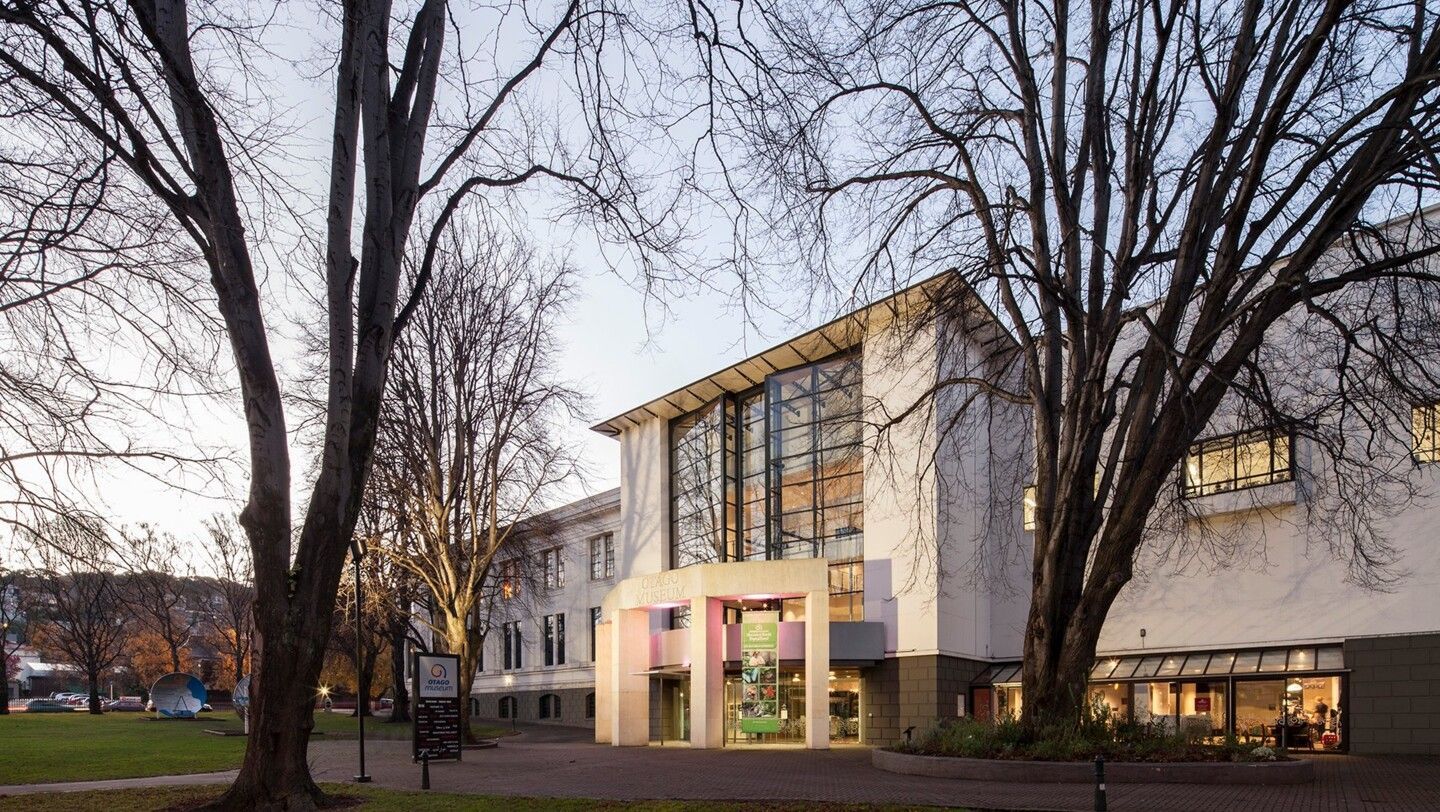 A large white building with trees in front of it