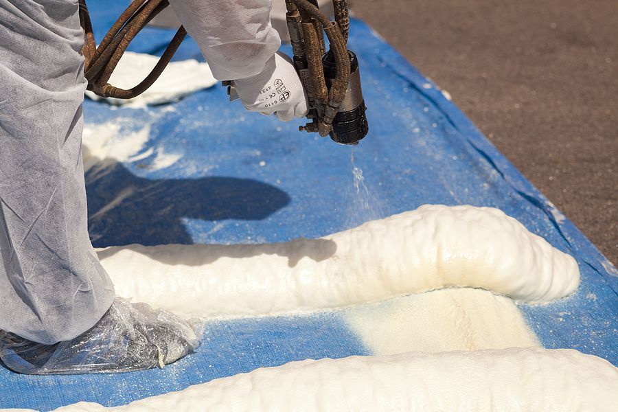a person is painting a piece of art with white paint