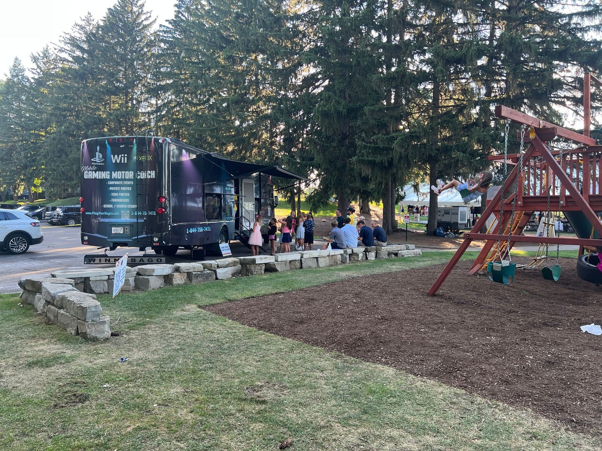 play your way truck is parked in a park next to a playground