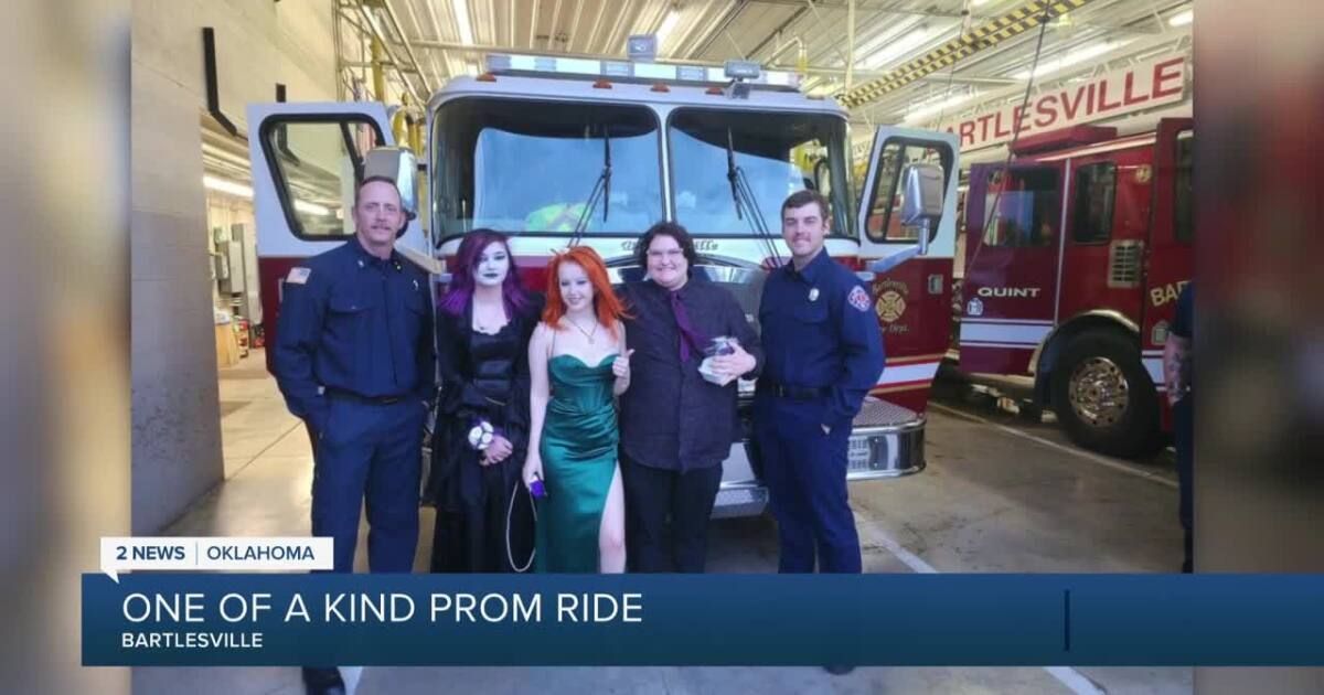 A group of people standing in front of a fire truck.