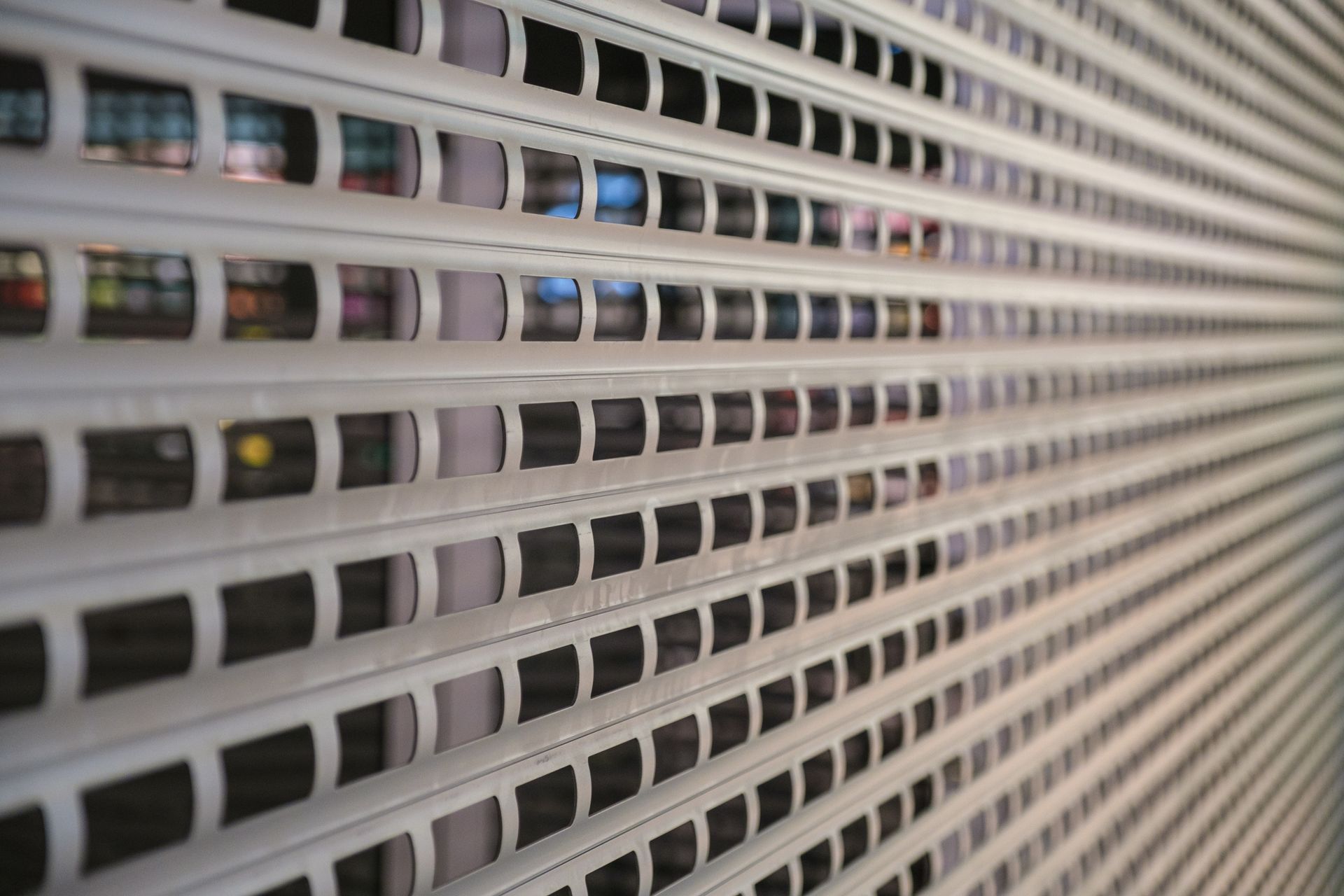 A close up of a metal wall with holes in it