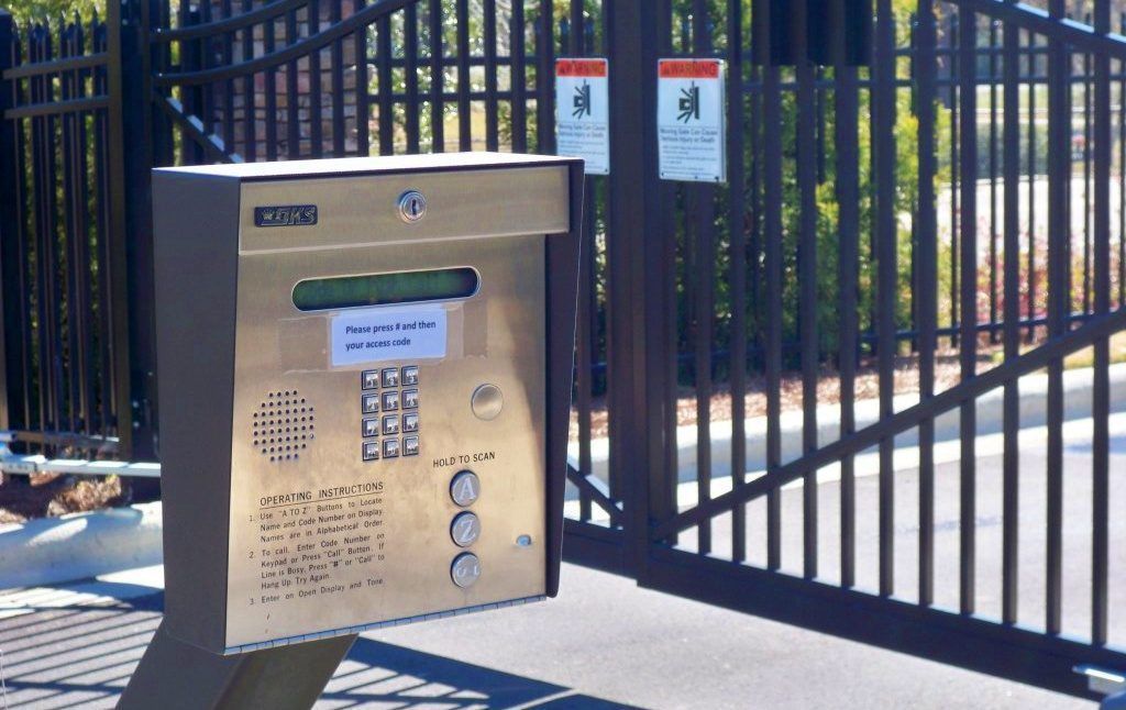 A gate with a keypad in front of it