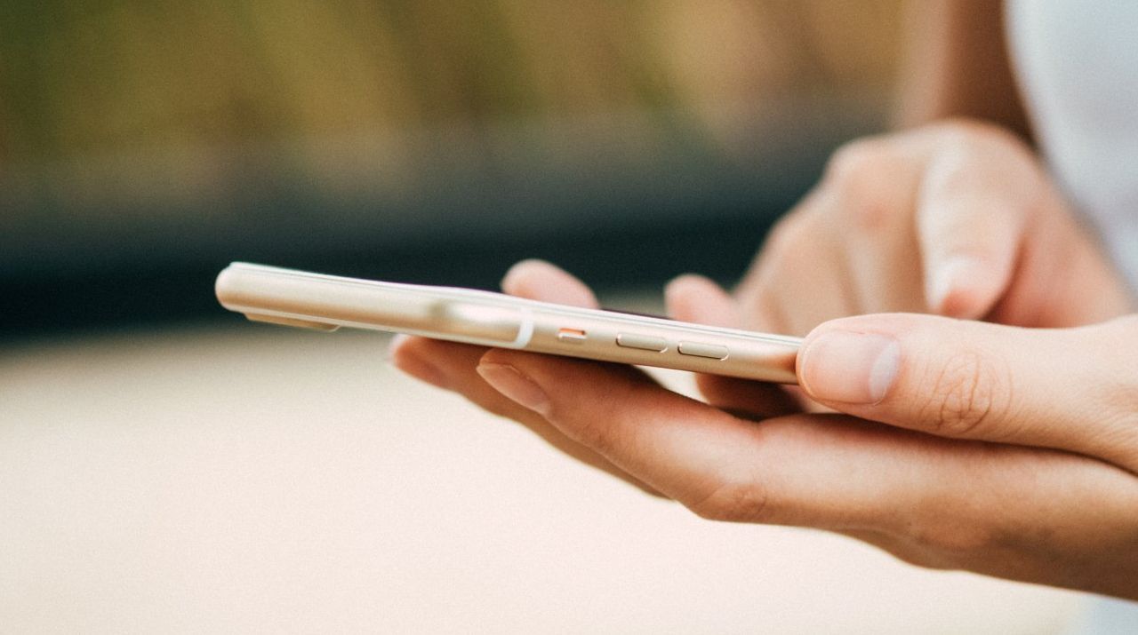A person is holding a cell phone in their hand.