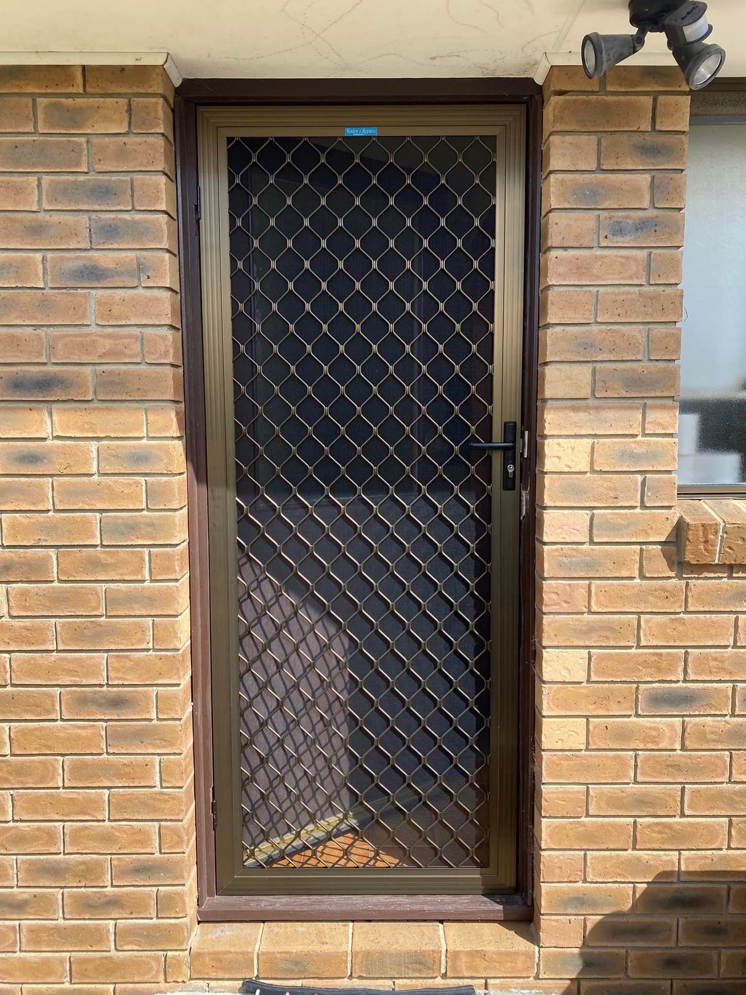 A Brown Metal Security Screen Door — Rodens Repairs Flyscreens and Doors In Forcett, TAS