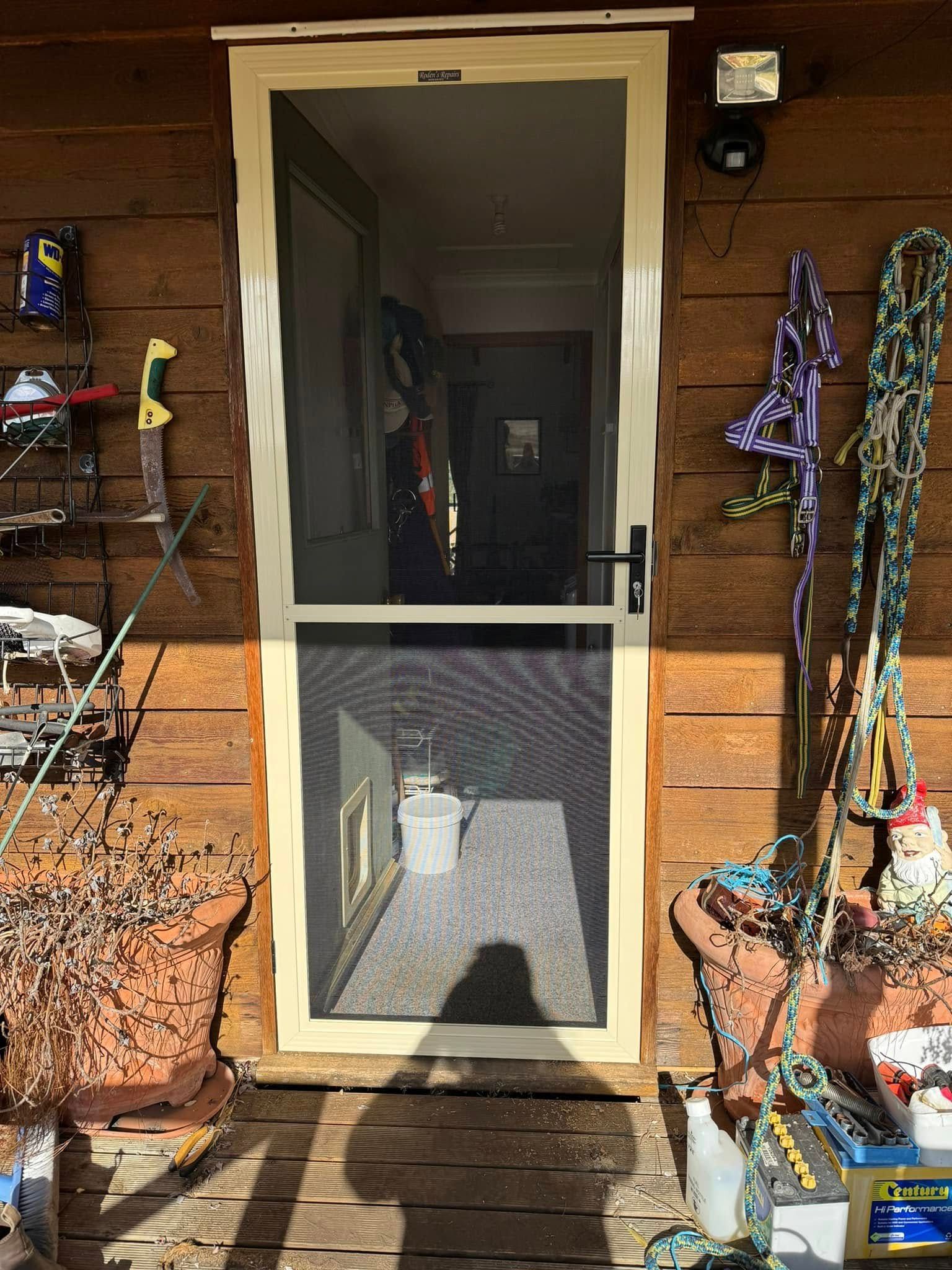A Beige Screen Door Installed in a Rustic — Rodens Repairs Flyscreens and Doors In Forcett, TAS