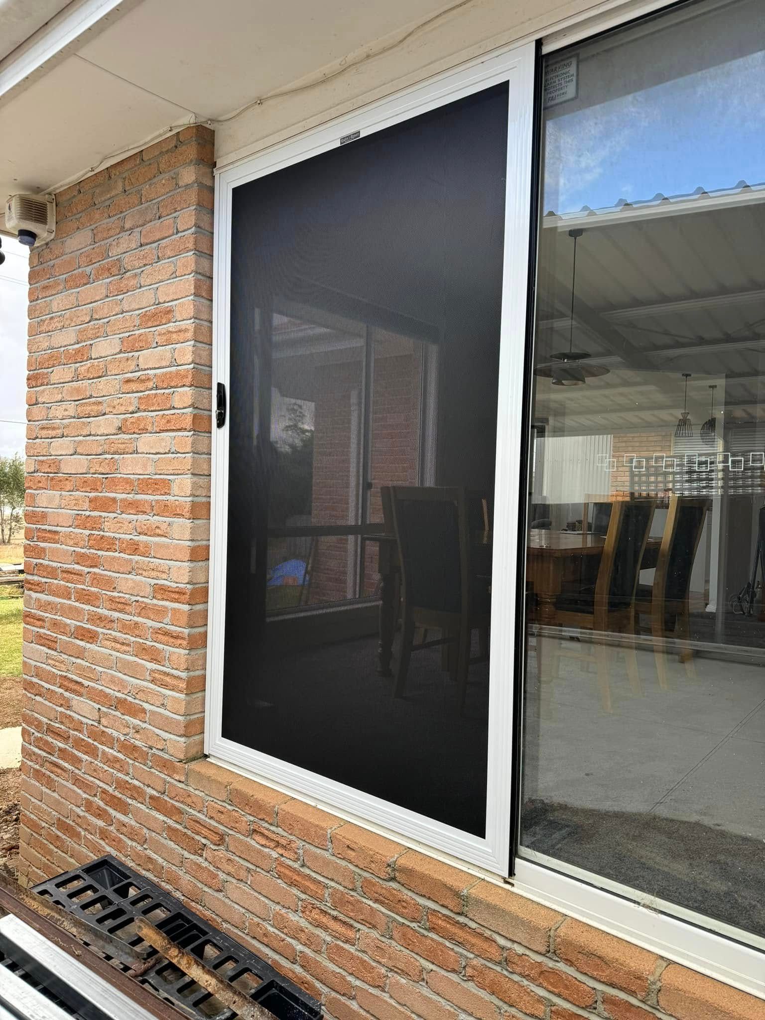 A Sliding Screen Door With a Black Mesh — Rodens Repairs Flyscreens and Doors In Forcett, TAS