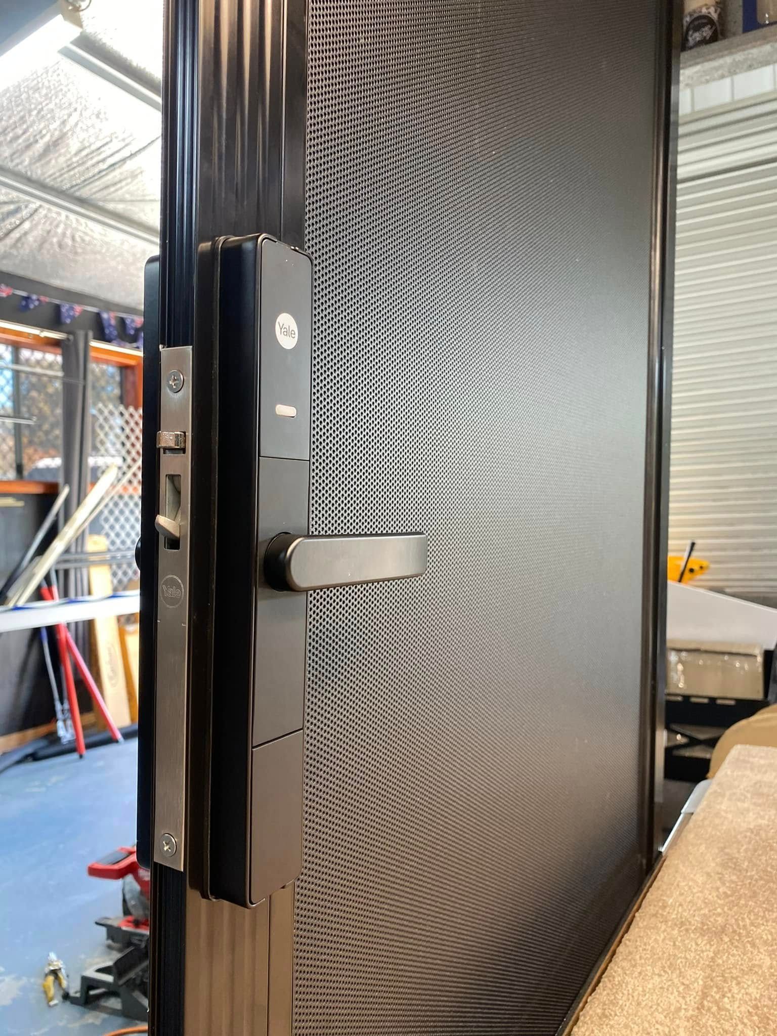 Black Smart Door Lock Installed on a Black Mesh Screen Door — Rodens Repairs Flyscreens and Doors In Forcett, TAS