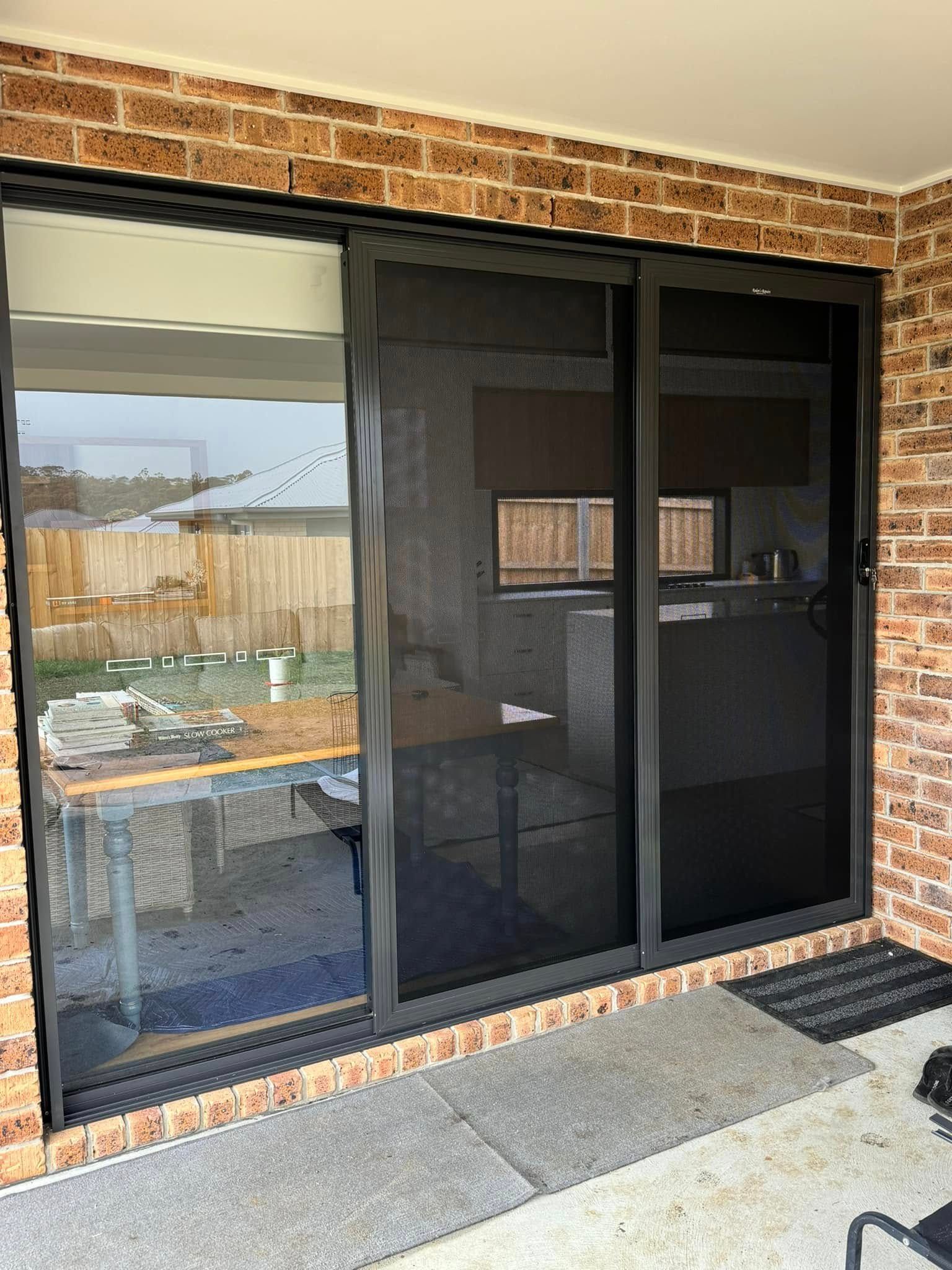 A Dark-framed Sliding Glass Door — Rodens Repairs Flyscreens and Doors In Forcett, TAS