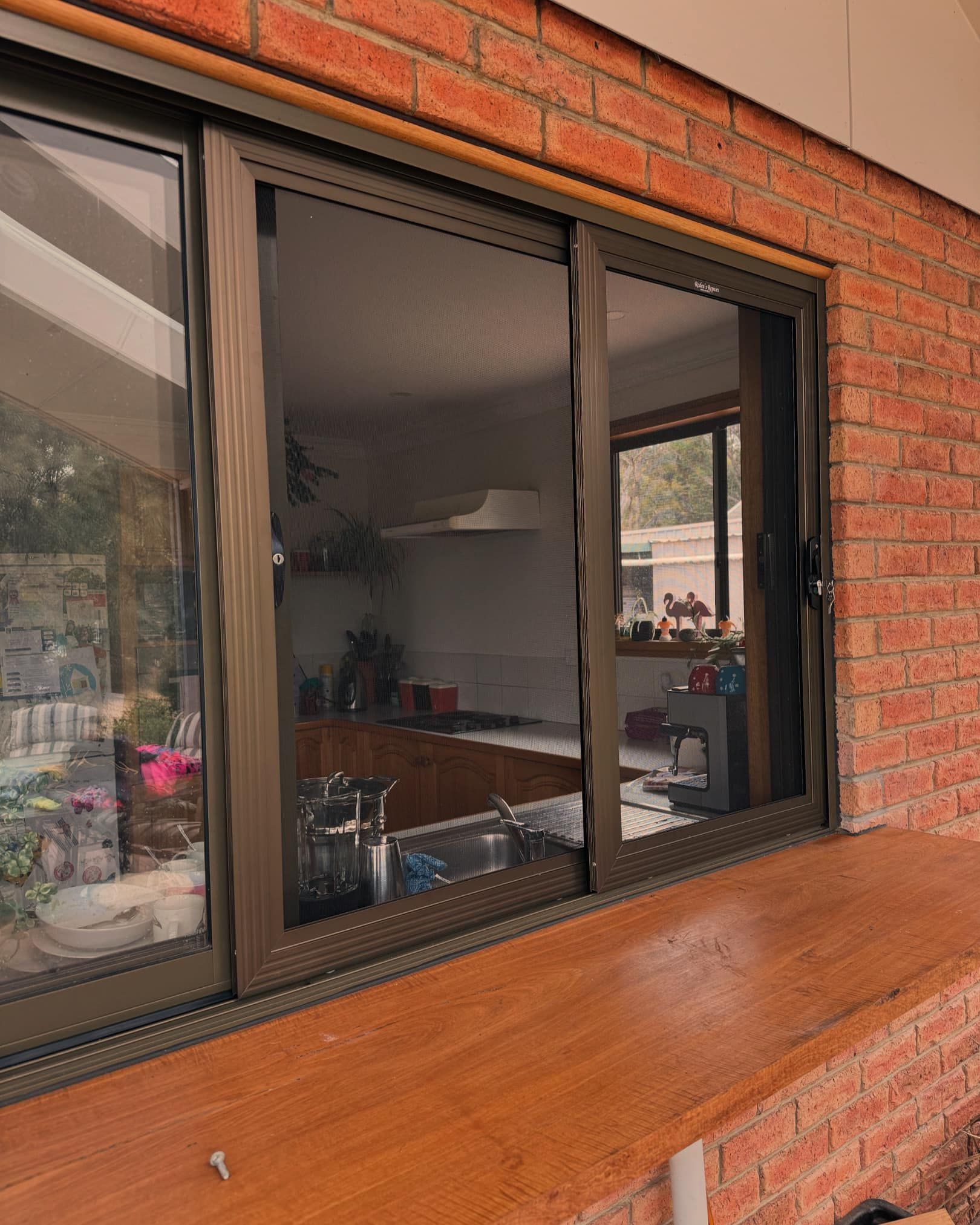 A Brown-framed Sliding Window — Rodens Repairs Flyscreens and Doors In Forcett, TAS