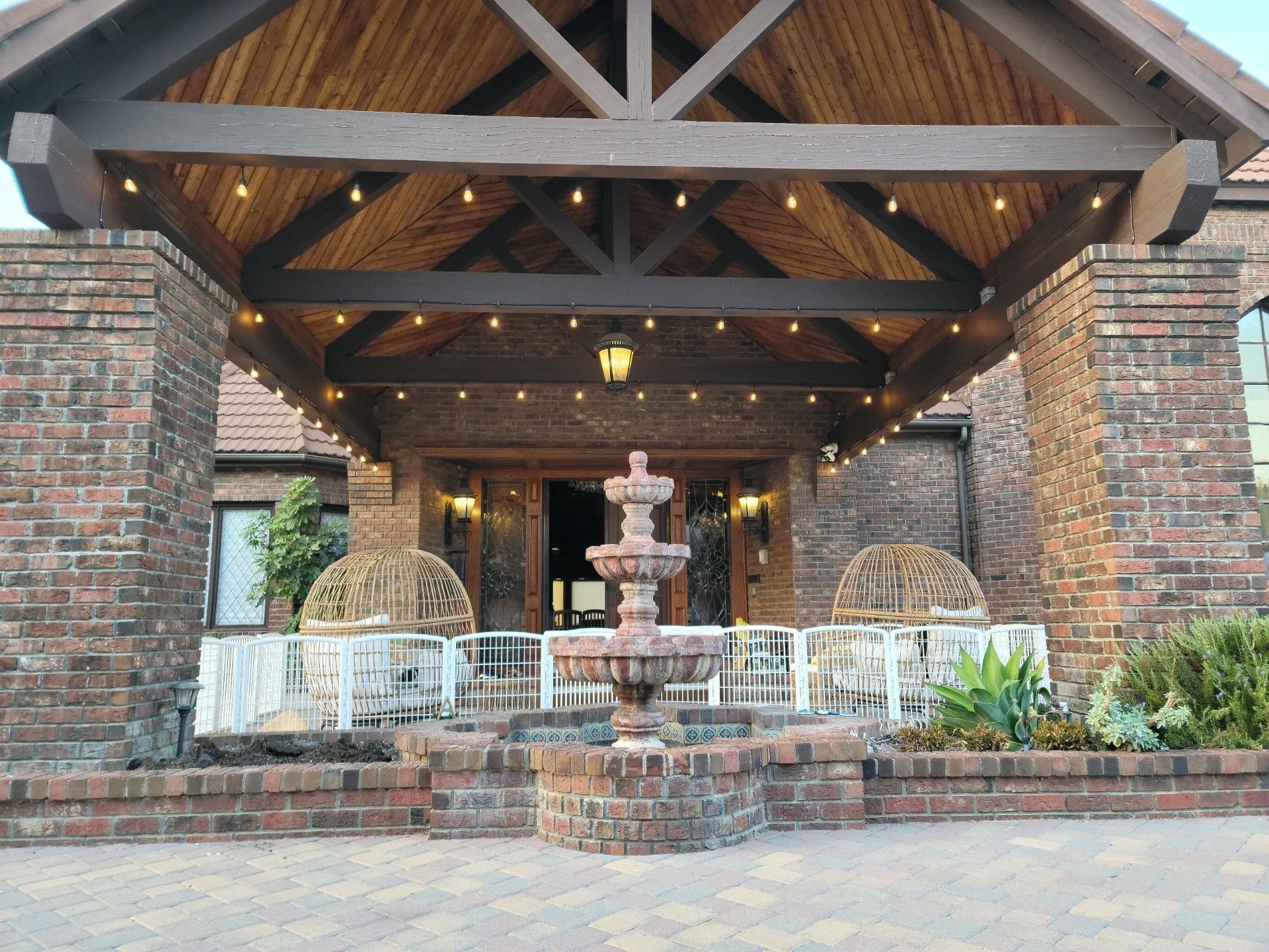 A brick building with a fountain in front of it
