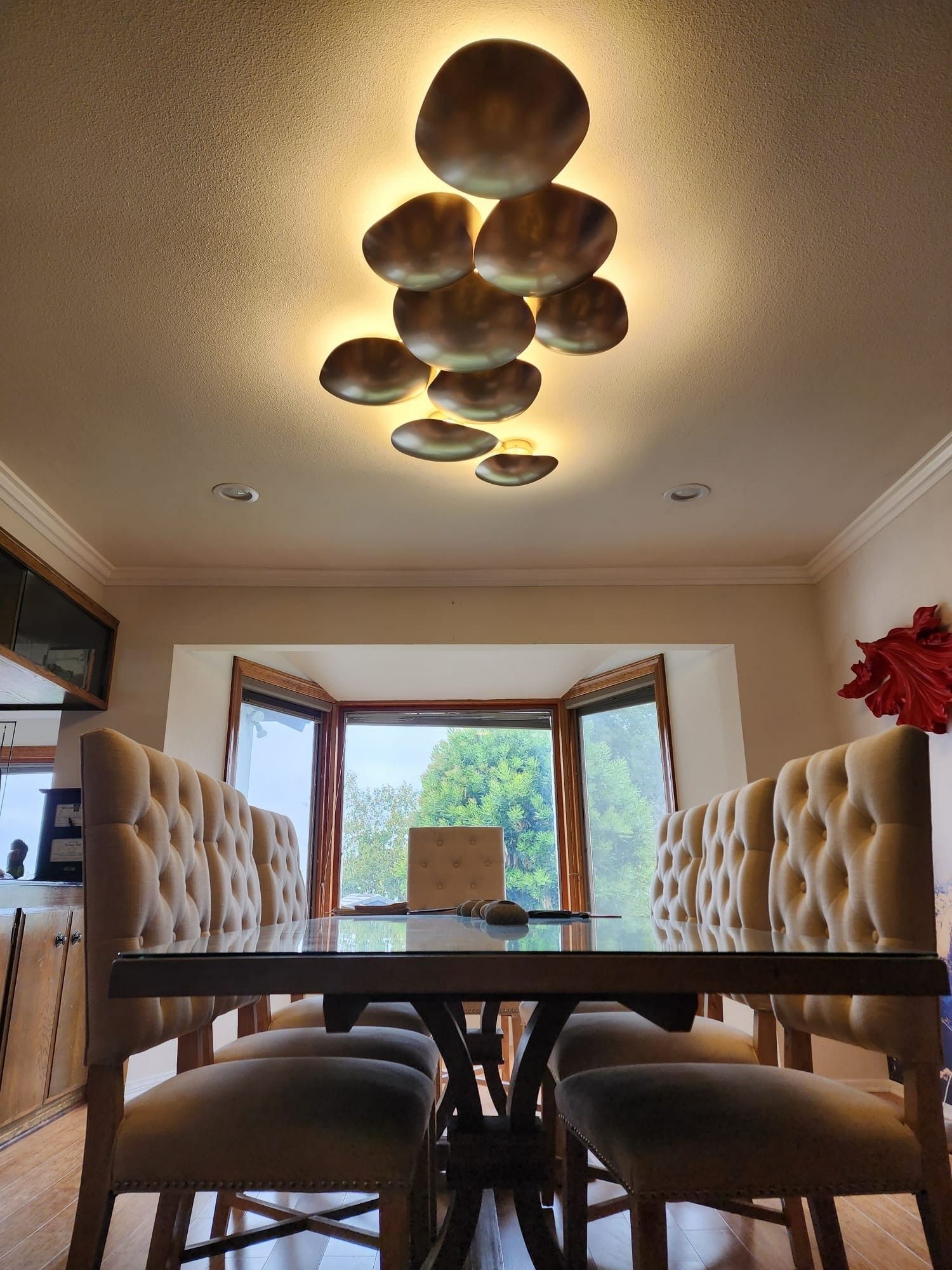 A dining room with a table and chairs and a window