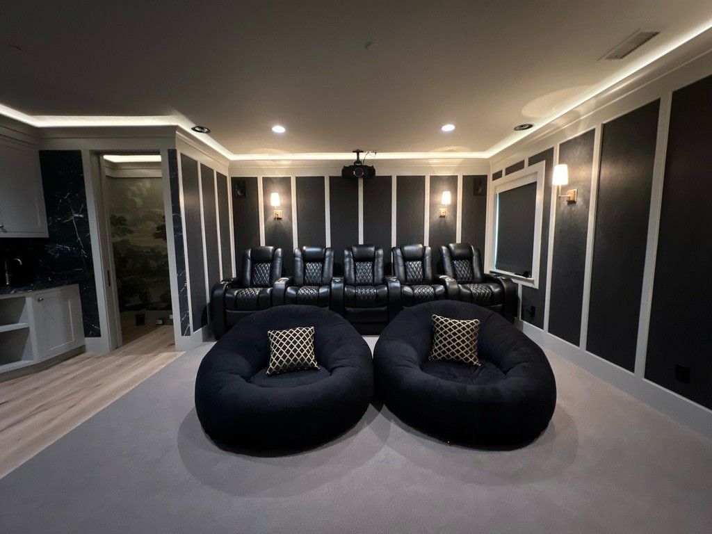 A home theater with two bean bag chairs and a projector.