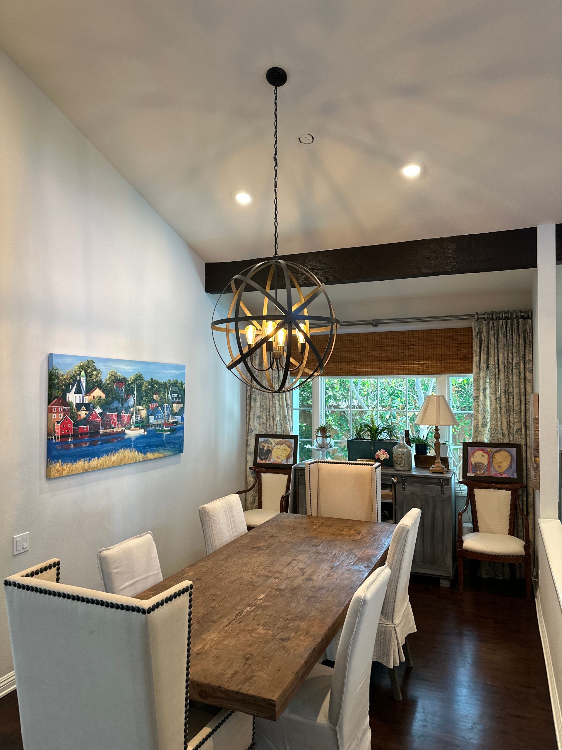 Nighttime outdoor patio with recessed lights, ceiling fans, and seating area.
