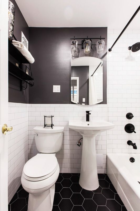 A bathroom with two sinks, a toilet, and a walk in shower.