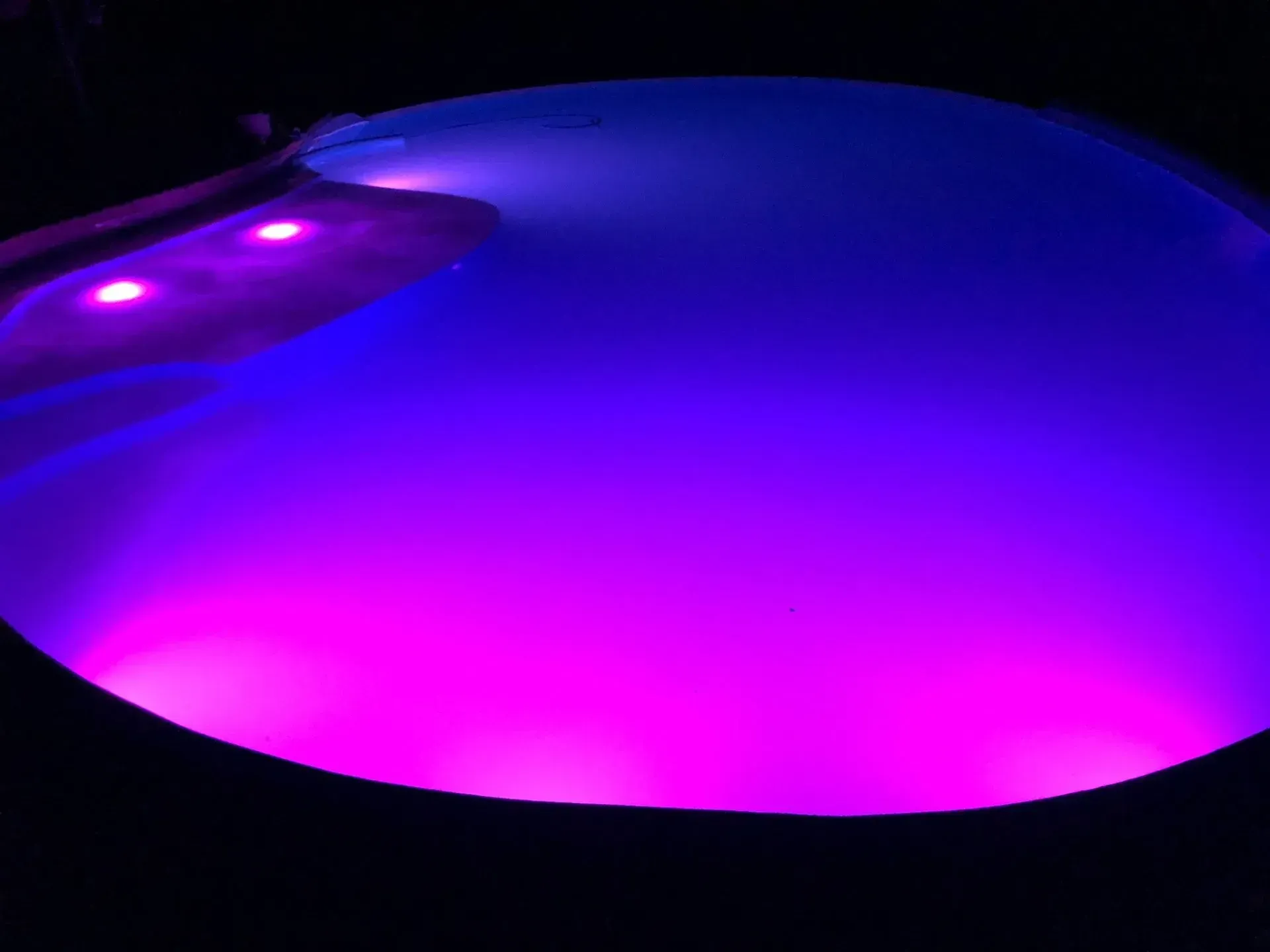 small pool at night with interior lighting