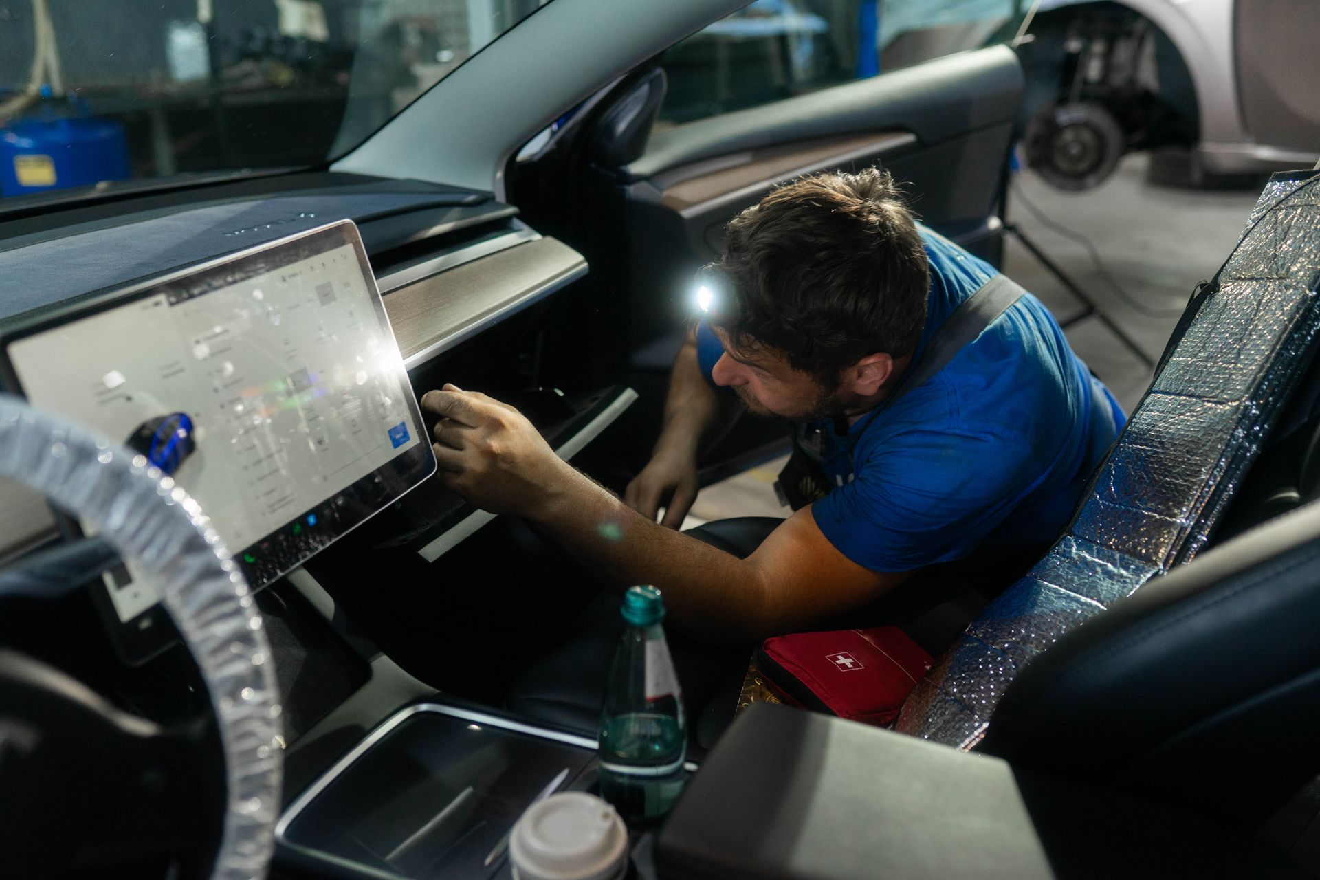 A man is inspecting a car.