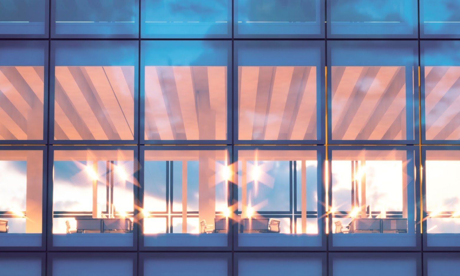 A close up of a building with a lot of windows at night.