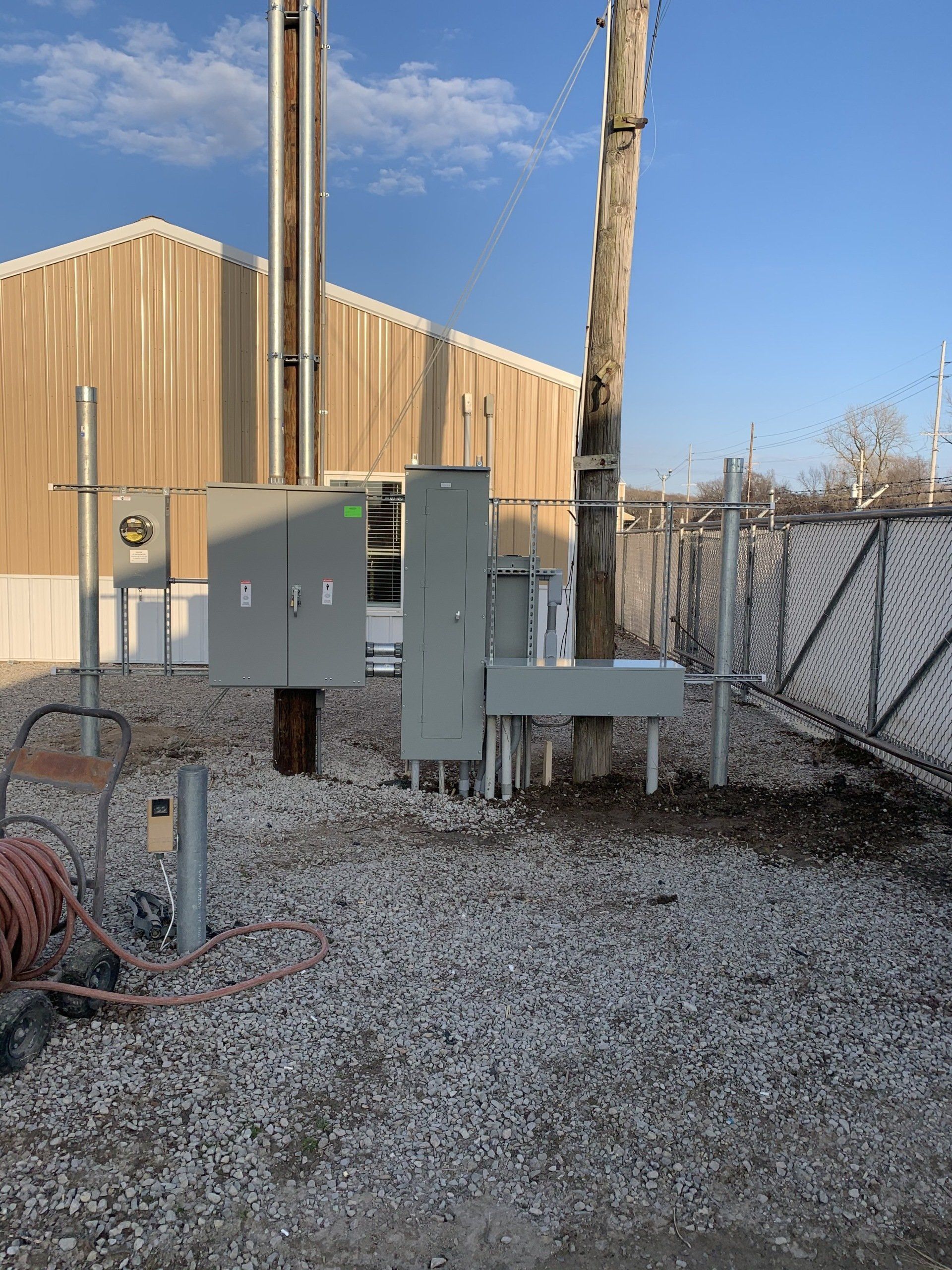 A large building with a lot of electrical equipment in front of it