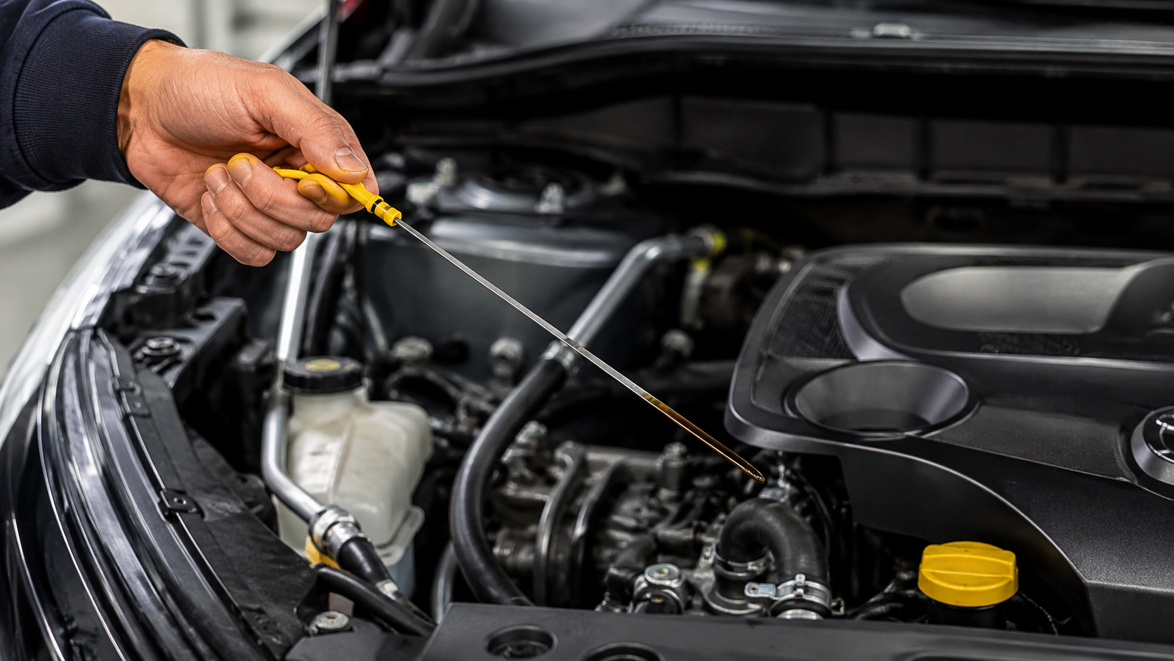 Checking engine oil level before scheduling an oil change